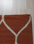 Maya Rustic Orange Hand Tufted Wool Rug, blending warm orange hues in a hand-tufted wool construction, displayed in a room setting, hinting at inviting comfort and rustic charm.