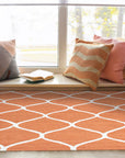 Maya Rustic Orange Hand Tufted Wool Rug, showcasing warm, rustic tones and a textured hand-tufted wool construction, subtly grounded in a neutral-toned living space.