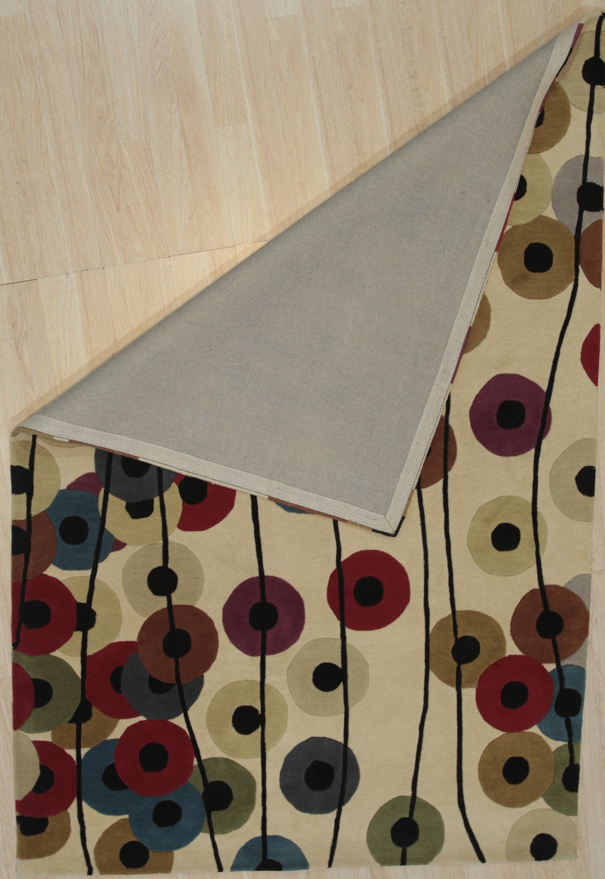 Modern Isla Multicolor Hand Tufted Wool Rug displayed in a living room setting, its vibrant hues and textured hand-tufted wool adding warmth to the space.