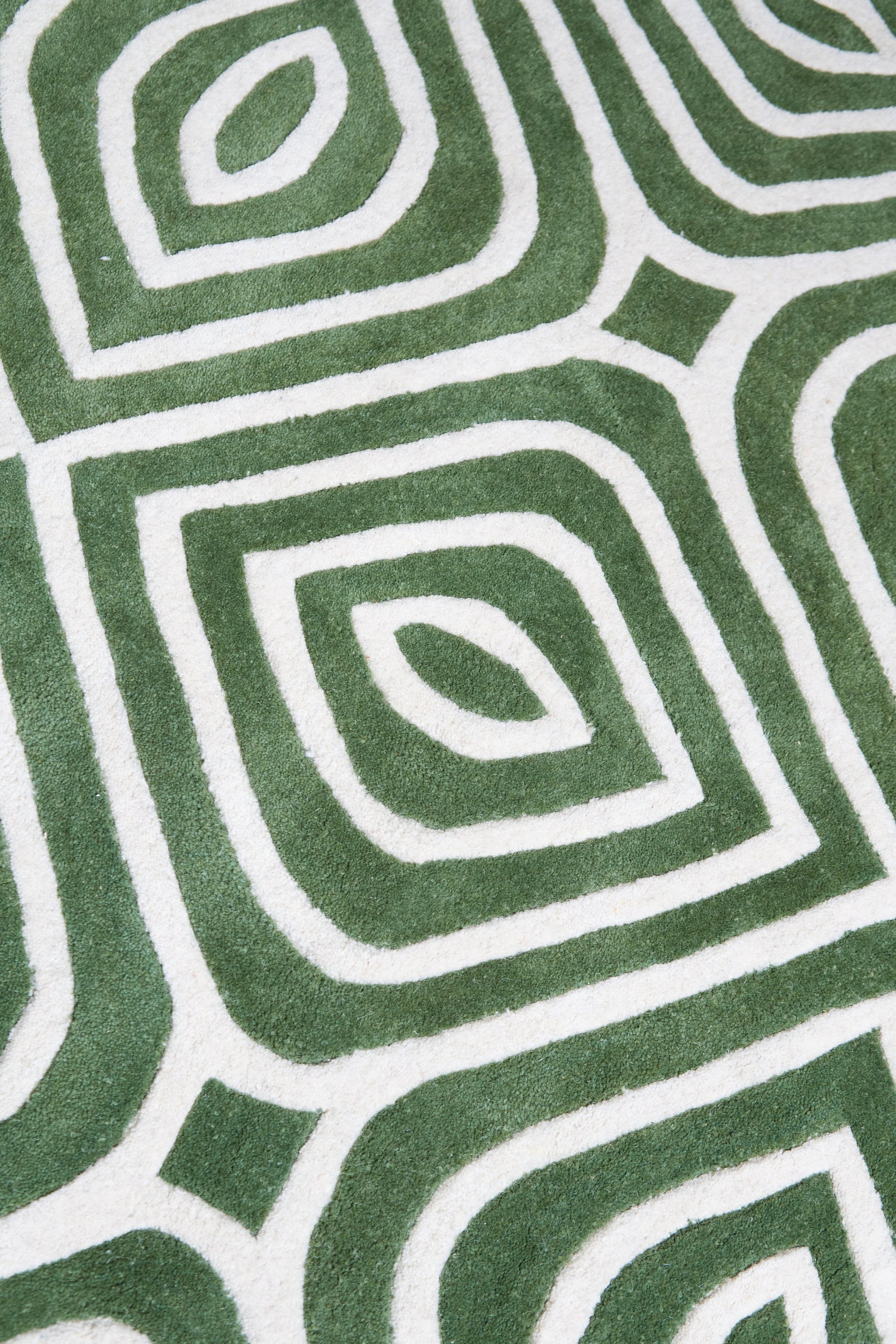 Radiant Amara Green Hand Tufted Wool Rug, showcasing its lush, deep green hue and textured wool pile in a modern living room setting.