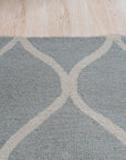 Handcrafted Laine Light Green Hand Tufted Wool Rug, a light green wool rug with a subtle textured design, displayed in a bright, naturally lit living space.