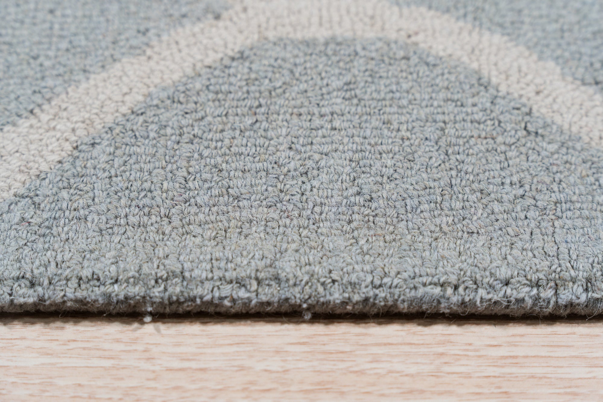 Handcrafted Laine Light Green Hand Tufted Wool Rug, a serene light green wool rug with a subtly textured surface, filling a comfortably appointed living room.