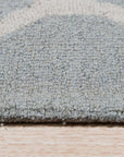 Handcrafted Laine Light Green Hand Tufted Wool Rug, a serene light green wool rug with a subtly textured surface, filling a comfortably appointed living room.