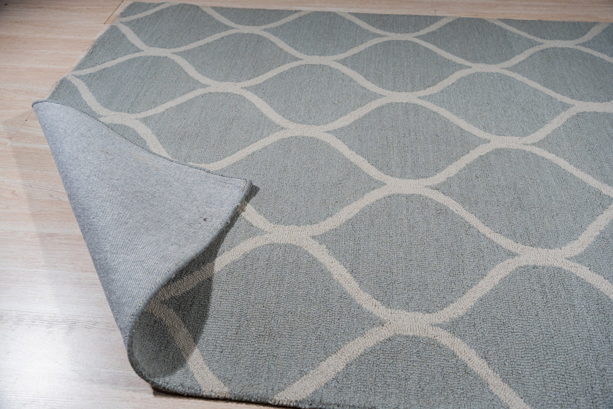 Handcrafted Laine Light Green Hand Tufted Wool Rug, its soft light green wool pile invitingly textured underfoot, complementing a bright, modern living space.