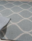 Handcrafted Laine Light Green Hand Tufted Wool Rug, its soft light green wool pile invitingly textured underfoot, complementing a bright, modern living space.