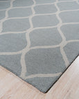 Handcrafted Laine Light Green Hand Tufted Wool Rug, offering a serene splash of pale green, softening a bright, modern living room with its plush wool texture and inviting warmth.