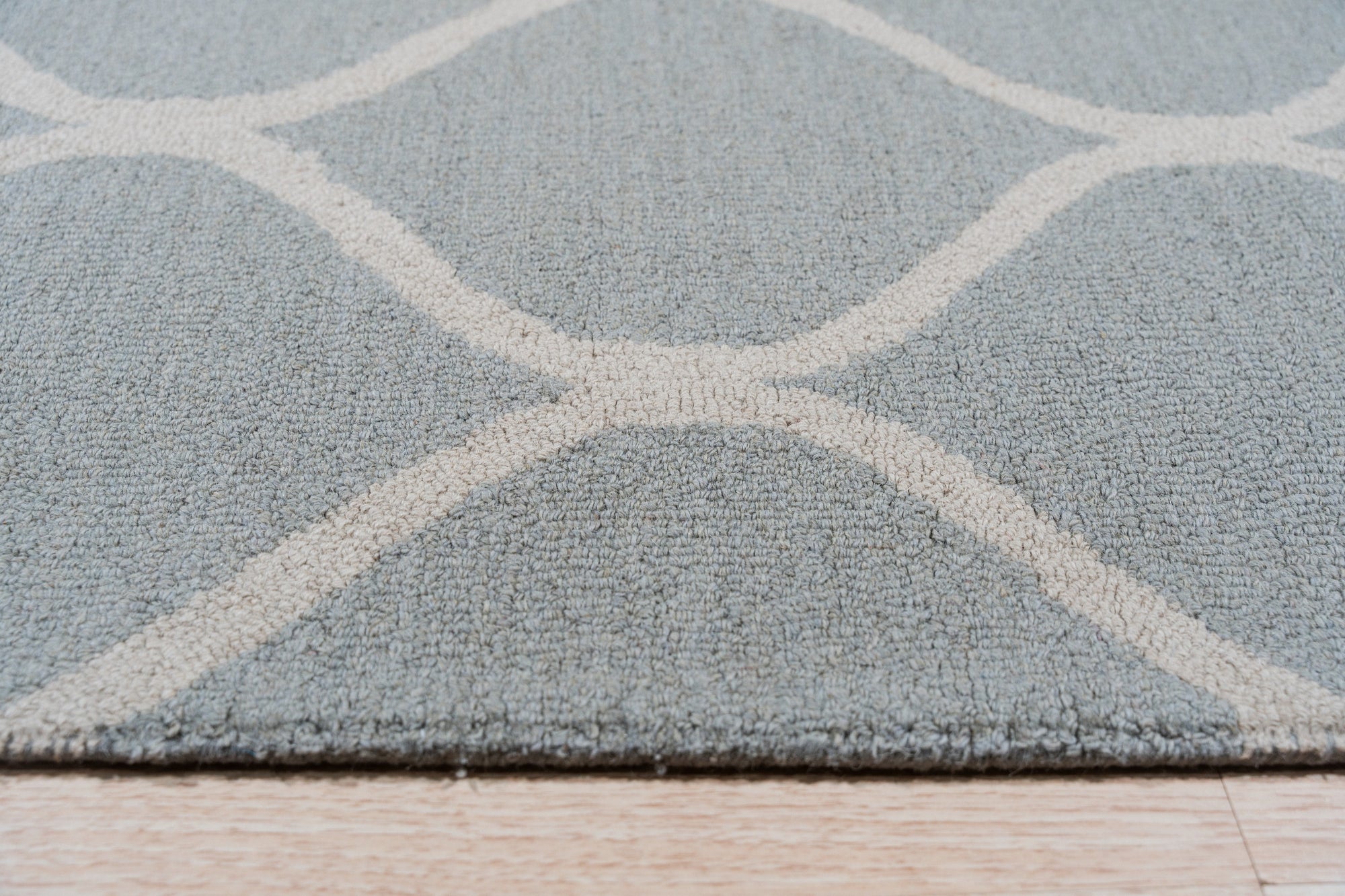 Handcrafted Laine Light Green Hand Tufted Wool Rug, soft light green texture and subtle pattern radiating warmth and comfort within a bright, airy living space.