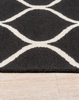 Sloane Willow Navy Hand Tufted Wool Rug graces a living room setting; the navy wool pile offers soft texture beneath furniture.