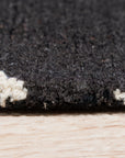 Sloane Willow Navy Hand Tufted Wool Rug, a navy wool rug with a flowing, organic design, displayed in a brightly lit interior setting.