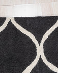 Sloane Willow Navy Hand Tufted Wool Rug in a living room setting; deep navy and cream tones accentuating a subtle willow leaf pattern in hand-tufted wool underfoot.