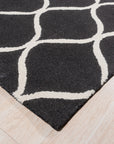 Sloane Willow Navy Hand Tufted Wool Rug, a navy wool rug with a willow-inspired design, seen in a brightly lit living space.