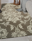 Amara Versatile Brown Hand Tufted Wool Rug, seen in a bright, inviting living room, features a subtle, organic pattern in warm browns and creams. Its hand-tufted wool construction adds texture and warmth to the neutral space.