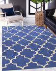 Dazzling Trellis Dark Blue Hand Tufted Wool Rug in a living room setting, showcasing its deep blue hue and geometric trellis pattern against light hardwood flooring.