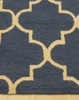 Dazzling Trellis Dark Blue Hand Tufted Wool Rug, its intricate trellis design in shades of blue and cream laid upon a dark blue field, hand-tufted from wool, adding warmth and texture to a living space.