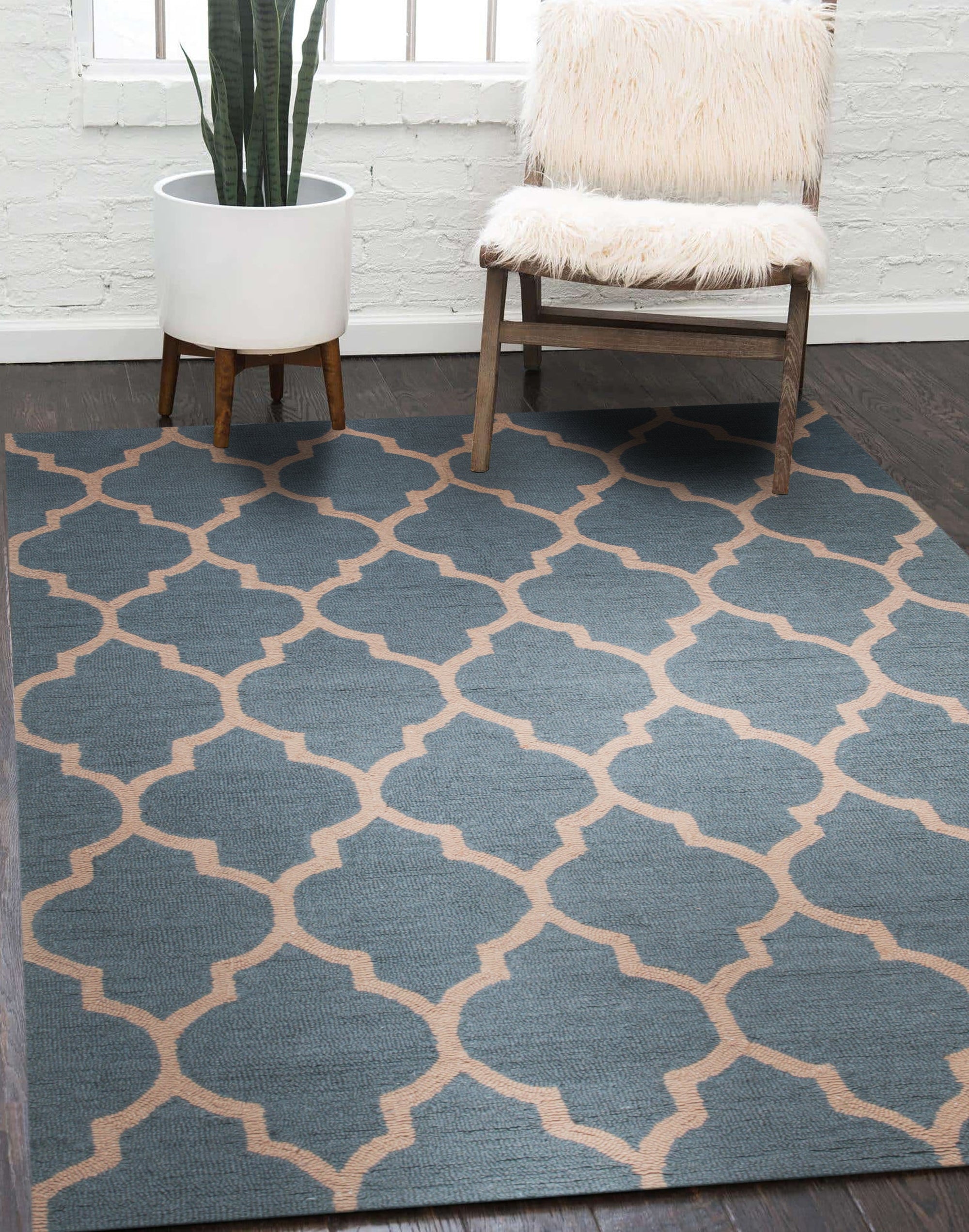 Ophelia Moroccan Midnight Hand Tufted Wool Rug, indigo and cream wool rug featuring a geometric Moroccan-inspired design, displayed in a brightly lit living room setting with contemporary furniture.