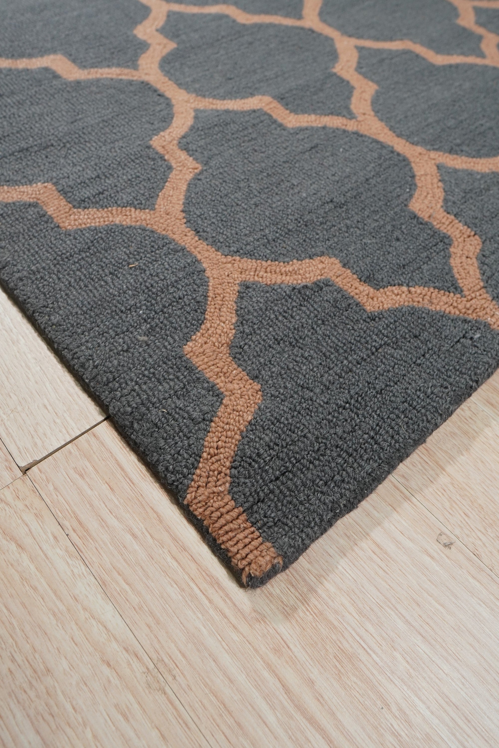Ophelia Moroccan Midnight Hand Tufted Wool Rug, dark blues and creams coalesce in a plush, hand-tufted wool rug, its geometric Moroccan pattern grounding a modern living room setting.