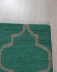 Giselle Moroccan Teal Green Hand Tufted Wool Rug, a teal green wool rug with a Moroccan-inspired design, displayed as part of a room setting, showcasing its texture and color variations.