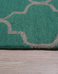 Giselle Moroccan Teal Green Hand Tufted Wool Rug, featuring intricate geometric patterns in shades of teal and green, adds a touch of bohemian elegance to a modern living space.