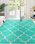 Giselle Moroccan Teal Green Hand Tufted Wool Rug, vibrant teal and green hues dance across hand-tufted wool, bringing a touch of Moroccan elegance to a softly lit room.