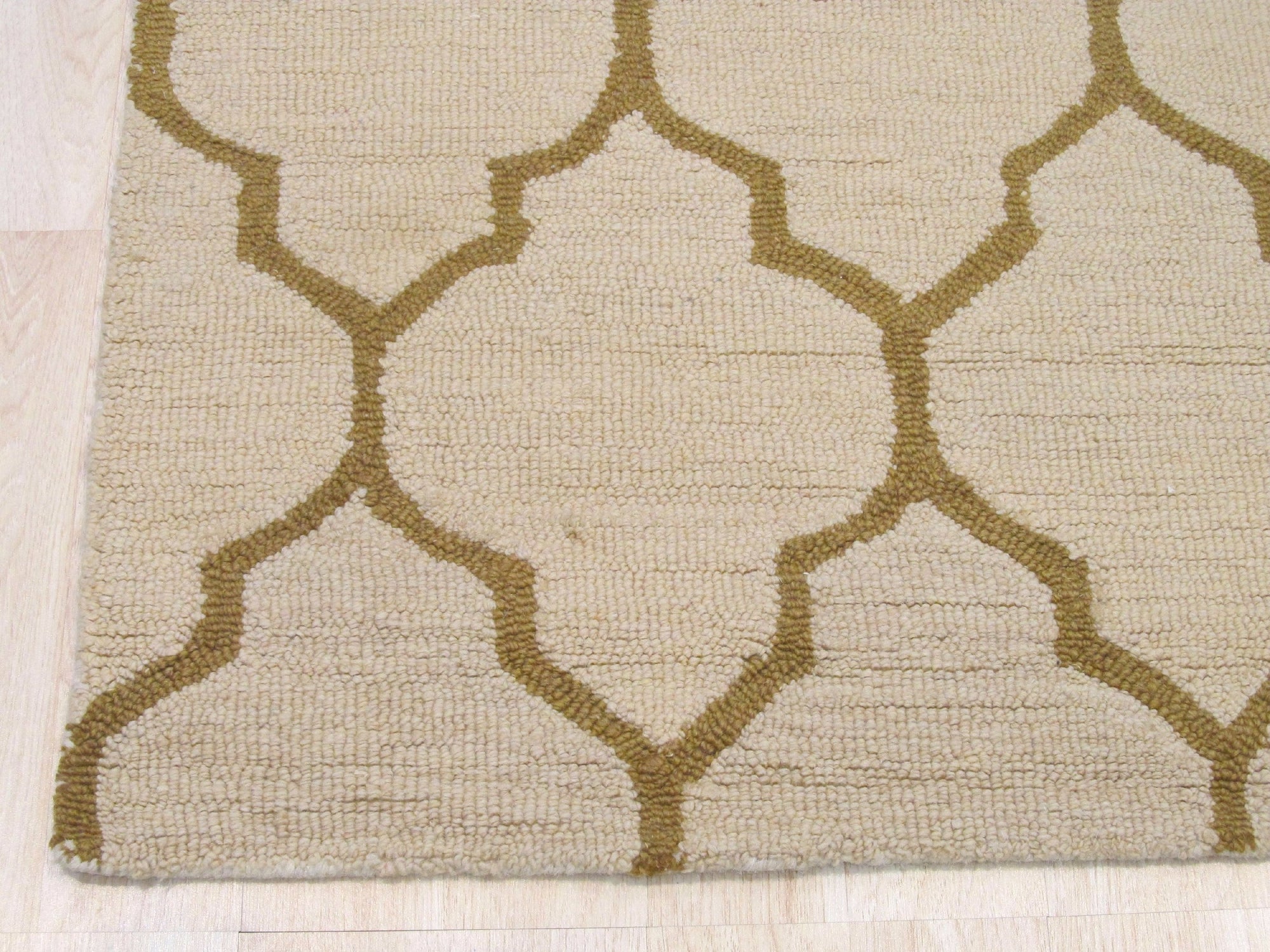 Ruby Trellis Light Beige Hand Tufted Wool Rug, light beige wool pile showcasing a repeating trellis pattern, seen in a bright interior setting.