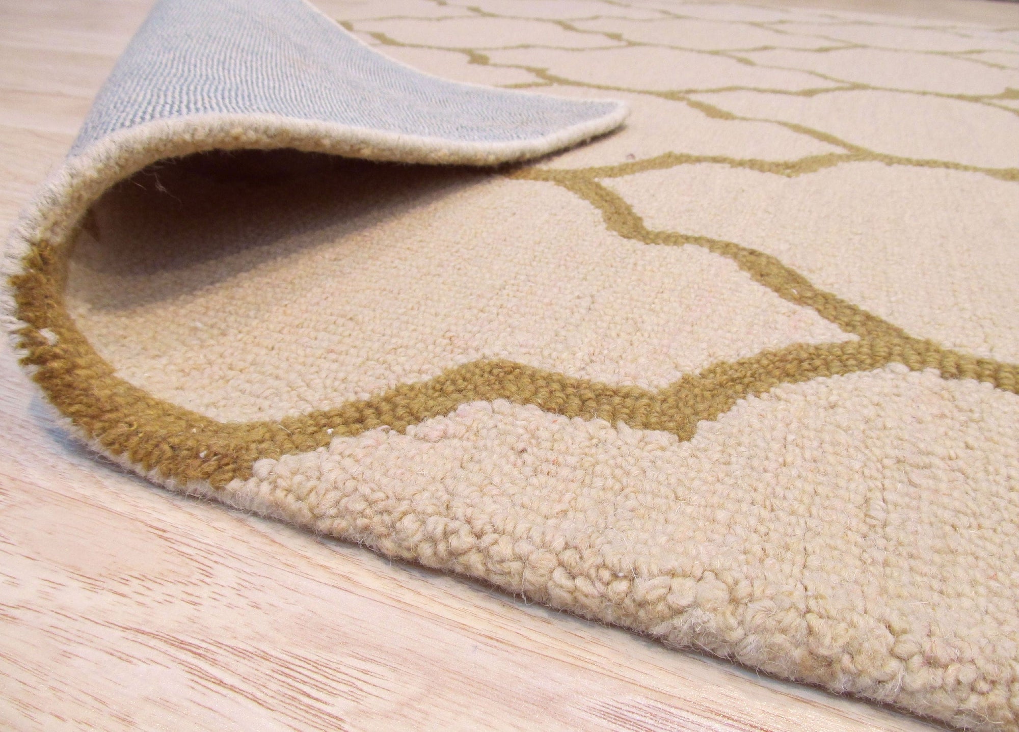 Ruby Trellis Light Beige Hand Tufted Wool Rug, displaying its intricate trellis pattern and soft light beige hue in a living room setting.