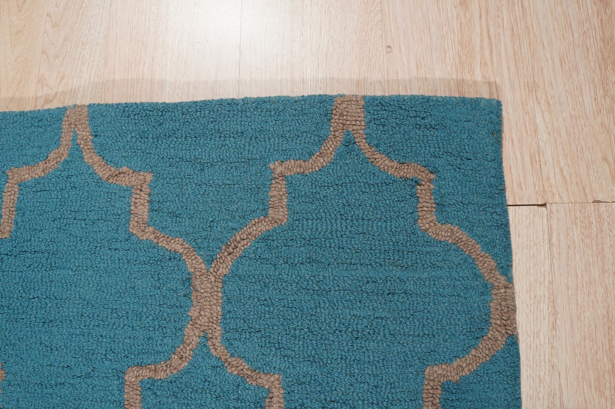 Sloane Moroccan Royal Blue Hand Tufted Wool Rug, its rich royal blue hues and intricate Moroccan design adding warmth and sophistication to a bright living space, showcasing a blend of traditional patterns and modern comfort.