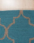 Sloane Moroccan Royal Blue Hand Tufted Wool Rug, its rich royal blue hues and intricate Moroccan design adding warmth and sophistication to a bright living space, showcasing a blend of traditional patterns and modern comfort.