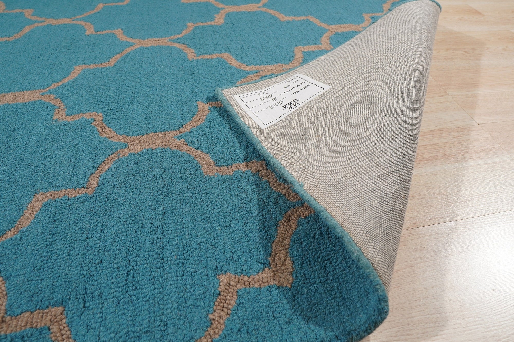 Sloane Moroccan Royal Blue Hand Tufted Wool Rug, vibrant royal blue wool rug featuring a geometric Moroccan-inspired design, showcased in a brightly lit living room setting.