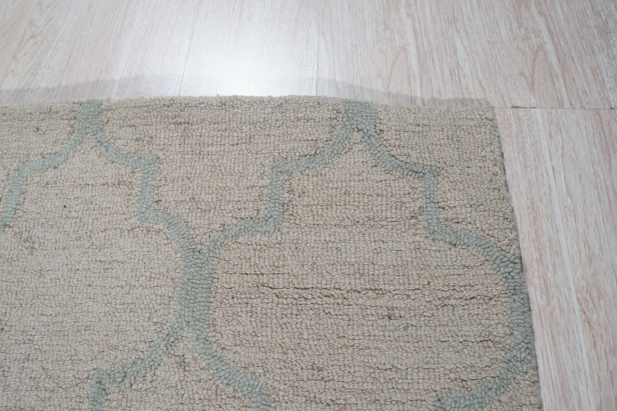 Vibrant Trellis Light Gold Hand Tufted Wool Rug, showcasing its elegant trellis pattern and light gold hues, nestled in a warmly lit living room.