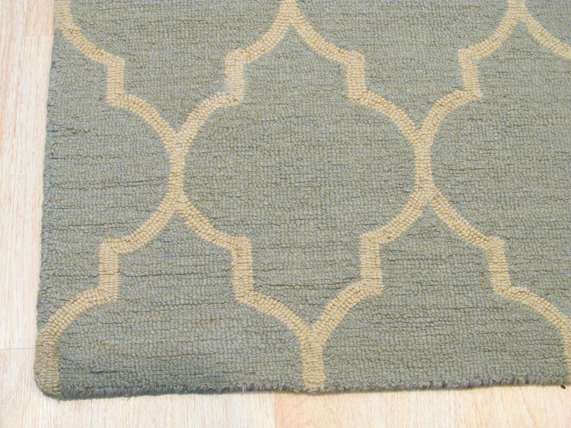 Opulent Moroccan Light Green Hand Tufted Wool Rug, a light green and wool rug with a Moroccan-inspired design, seen in a staged room setting with modern furniture.
