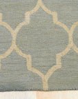 Opulent Moroccan Light Green Hand Tufted Wool Rug, a light green and wool rug with a Moroccan-inspired design, seen in a staged room setting with modern furniture.