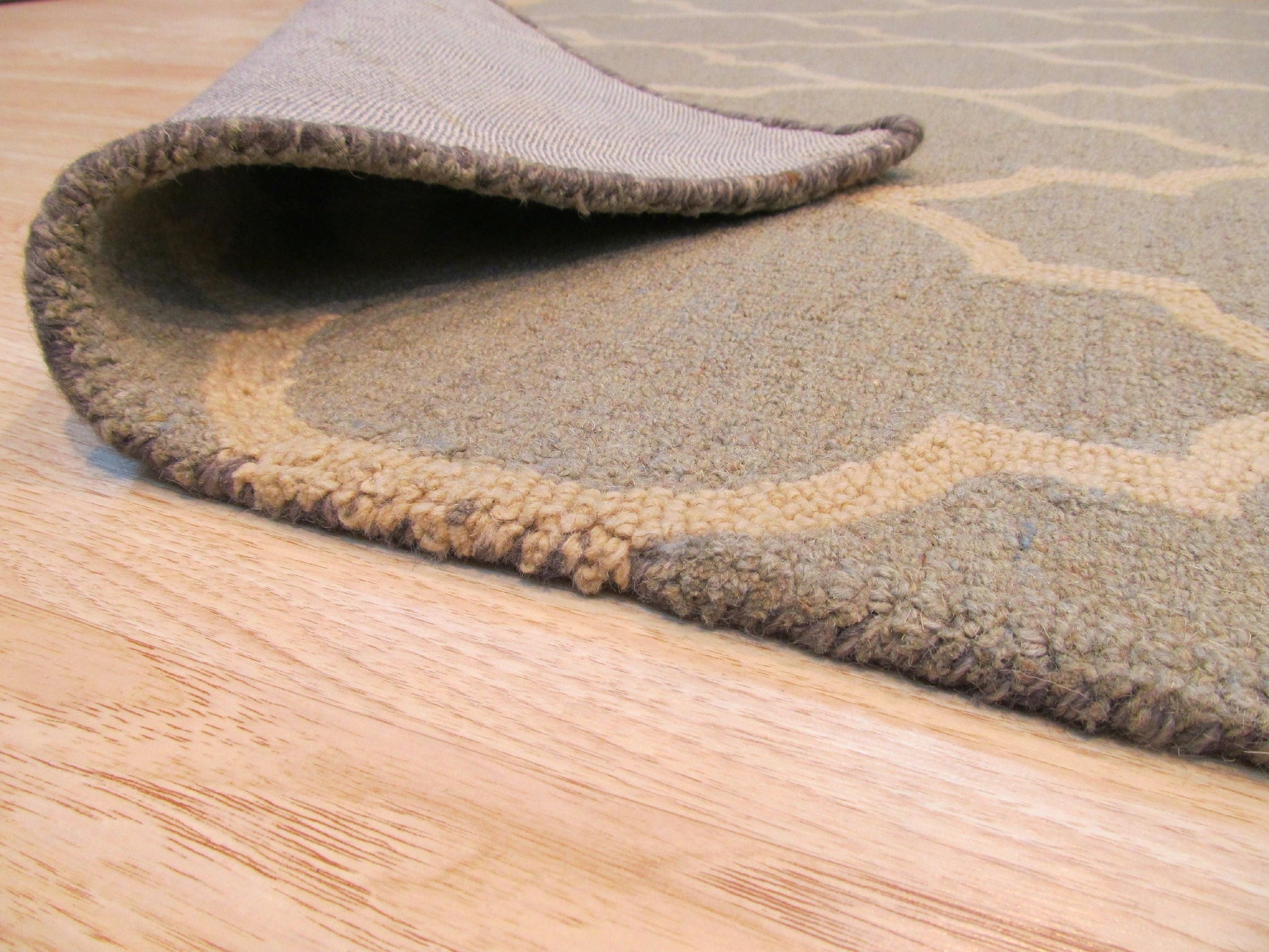 Opulent Moroccan Light Green Hand Tufted Wool Rug, a soft light green wool rug with a textured, geometric Moroccan-inspired design, anchoring a bright living room setting.