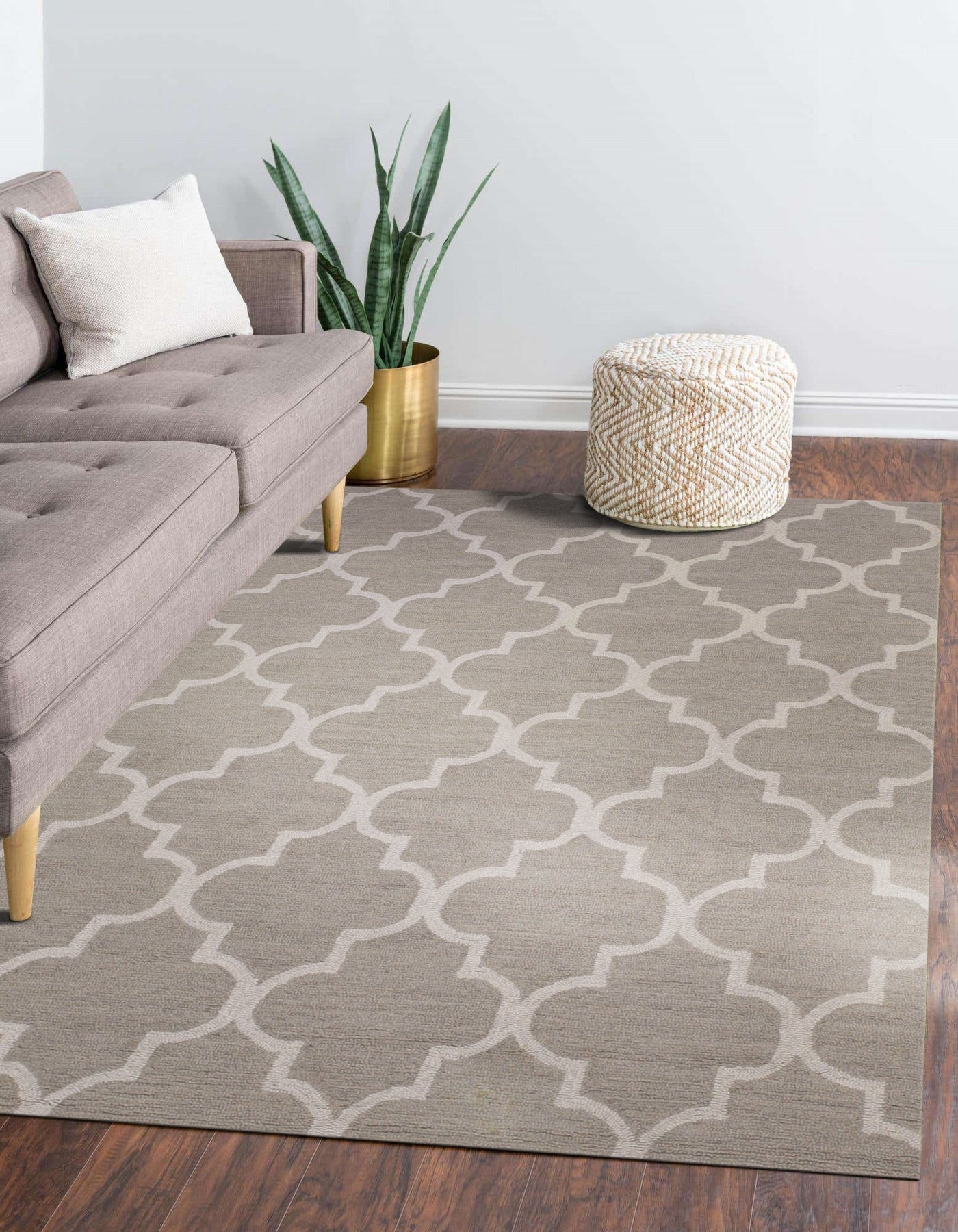 Trendy Moroccan Light Gray Hand Tufted Wool Rug anchoring a modern living room; soft light gray wool pile contrasts with a dark wooden coffee table. The hand-tufted texture is visible, suggesting a plush and inviting feel in the minimalist space.