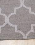 Trendy Moroccan Light Gray Hand Tufted Wool Rug, its soft, light gray wool pile adding subtle texture and warmth to a modern living room setting with neutral furniture.