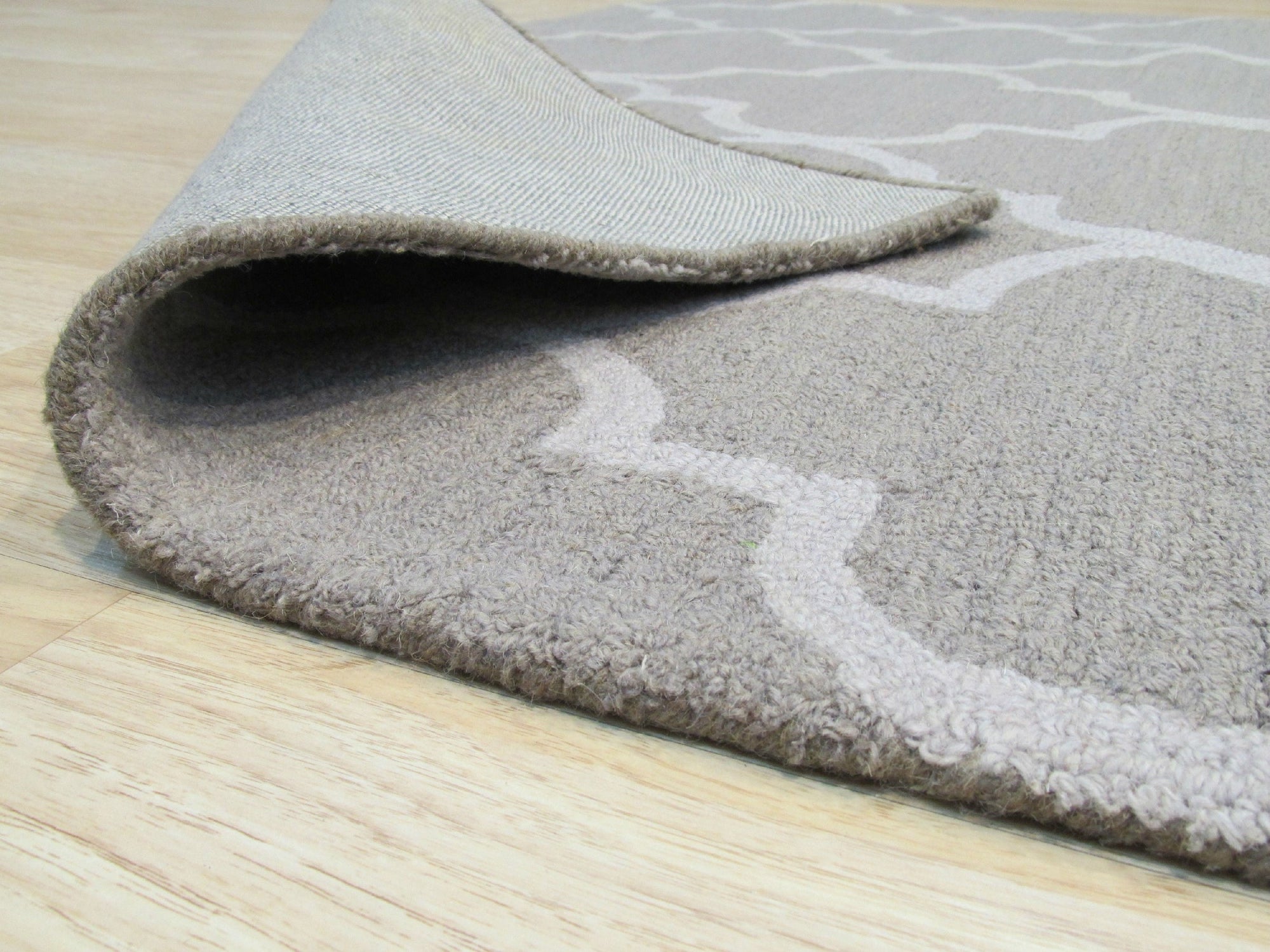 Trendy Moroccan Light Gray Hand Tufted Wool Rug, displaying intricate geometric patterns in soft light gray wool, filling a cozy living space.