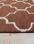 Trendy Moroccan Rust Hand Tufted Wool Rug, a rich rust and cream rug featuring a geometric Moroccan-inspired design, adds warmth and texture to a living space.