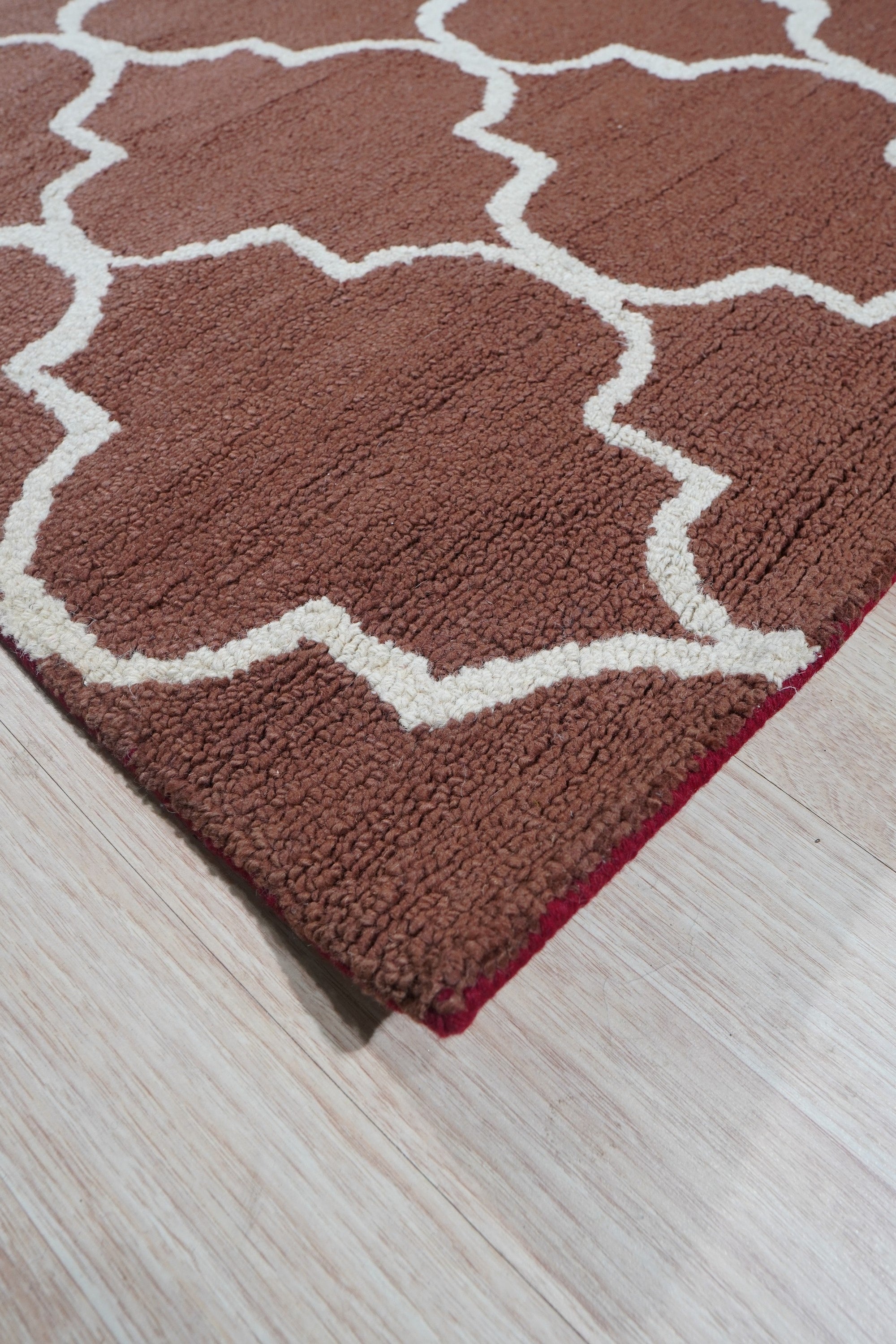 Trendy Moroccan Rust Hand Tufted Wool Rug, its rich rust hues and textured hand-tufted wool create a warm, inviting atmosphere in a modern living space.