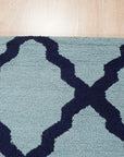 Bianca Trellis Sea Blue Hand Tufted Wool Rug, a soft sea blue wool rug with a classic trellis design, displayed in a bright, modern living space.