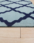 Bianca Trellis Sea Blue Hand Tufted Wool Rug, showcasing its cool sea blue hue and intricate trellis pattern in a room setting.