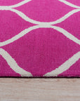 Willow Ella Pink Hand Tufted Wool Rug, soft pink wool blooms across a subtly patterned background, creating a comforting texture underfoot in a brightly lit room.