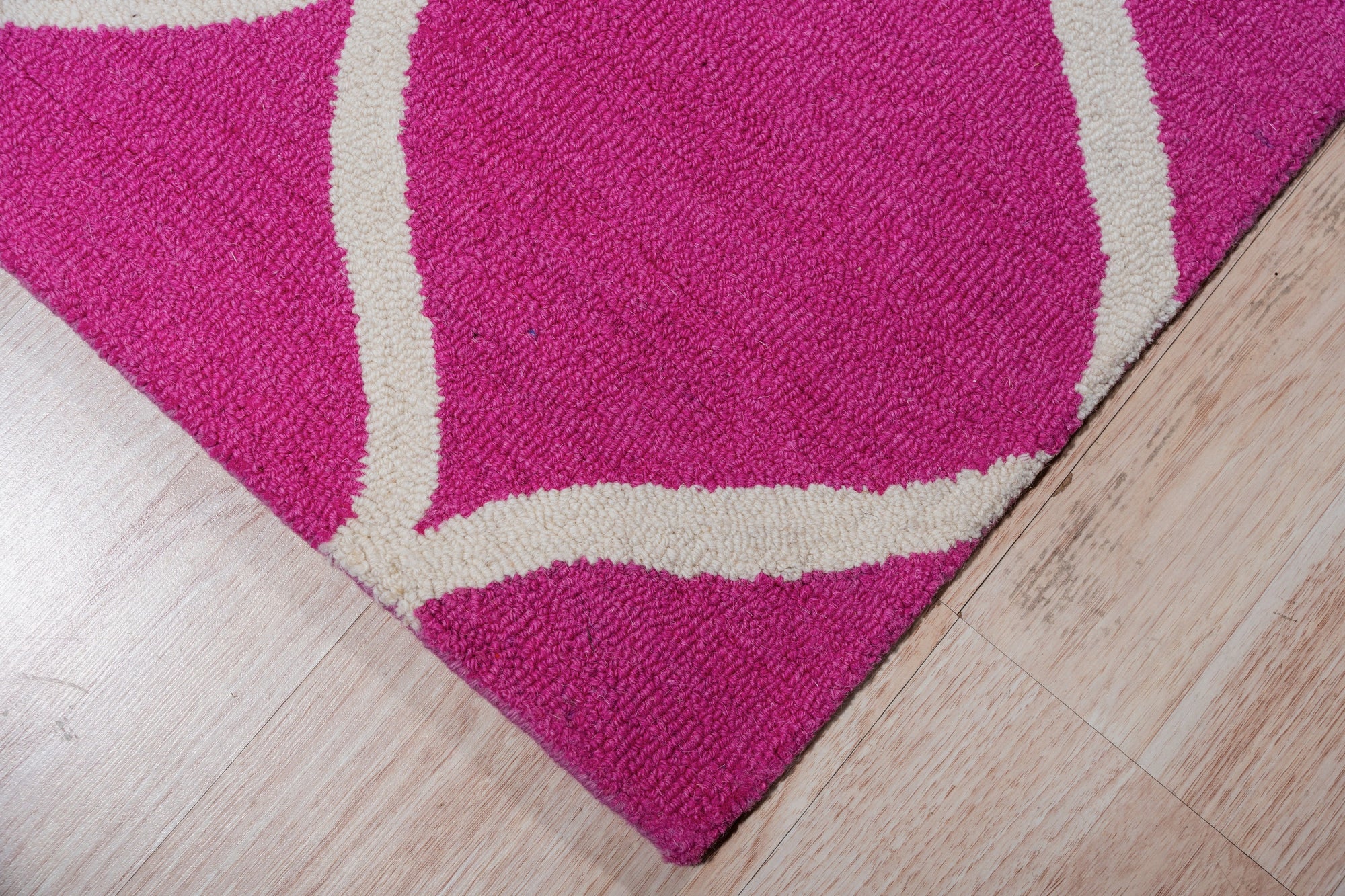 Willow Ella Pink Hand Tufted Wool Rug, soft pink and ivory tones blend in a hand-tufted wool rug with a subtle floral design, softening a modern living space.
