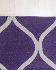Lush Handcrafted Purple Hand Tufted Wool Rug, a plush expanse of rich purple wool, its hand-tufted construction evident in the luxurious pile and subtle textural variations, inviting touch and adding a touch of regal comfort to any space.