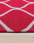 Delicate Enchanting Red Hand Tufted Wool Rug, a vibrant red wool rug with an intricate hand-tufted design, displayed on a light wooden floor.