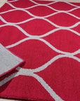 Delicate Enchanting Red Hand Tufted Wool Rug, showcasing intricate patterns and rich red hues, adds warmth and elegance to a softly lit interior.