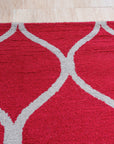 Delicate Enchanting Red Hand Tufted Wool Rug, vibrant red wool radiating warmth and texture, hand-tufted detailing visible within a softly lit interior setting.
