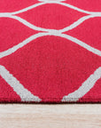 Delicate Enchanting Red Hand Tufted Wool Rug, vibrant crimson hand-tufted wool rug with intricate floral motifs, warmly complementing a sunlit living room setting.