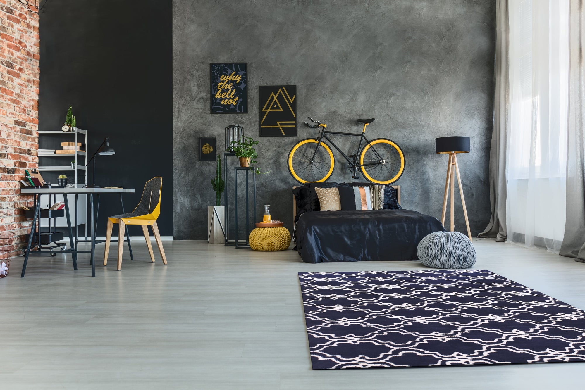 Penelope Moroccan Blue Hand Tufted Wool Rug, its intricate geometric patterns in shades of blue and cream adding warmth to a bright living space, crafted from soft hand-tufted wool.