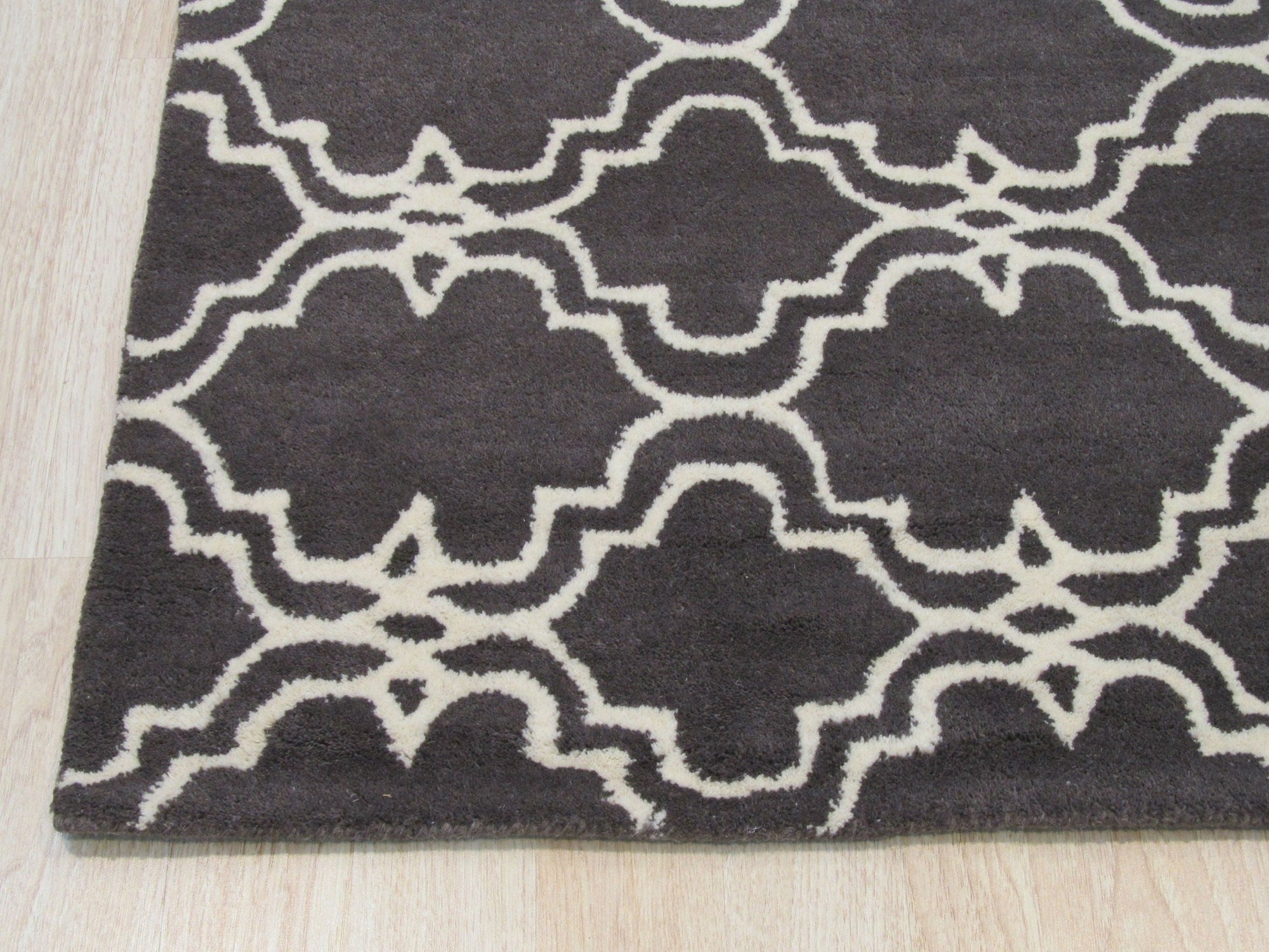 Refined Moroccan Gray Hand Tufted Wool Rug, soft gray tones and textured design anchoring a contemporary living room with sleek furniture and warm lighting.