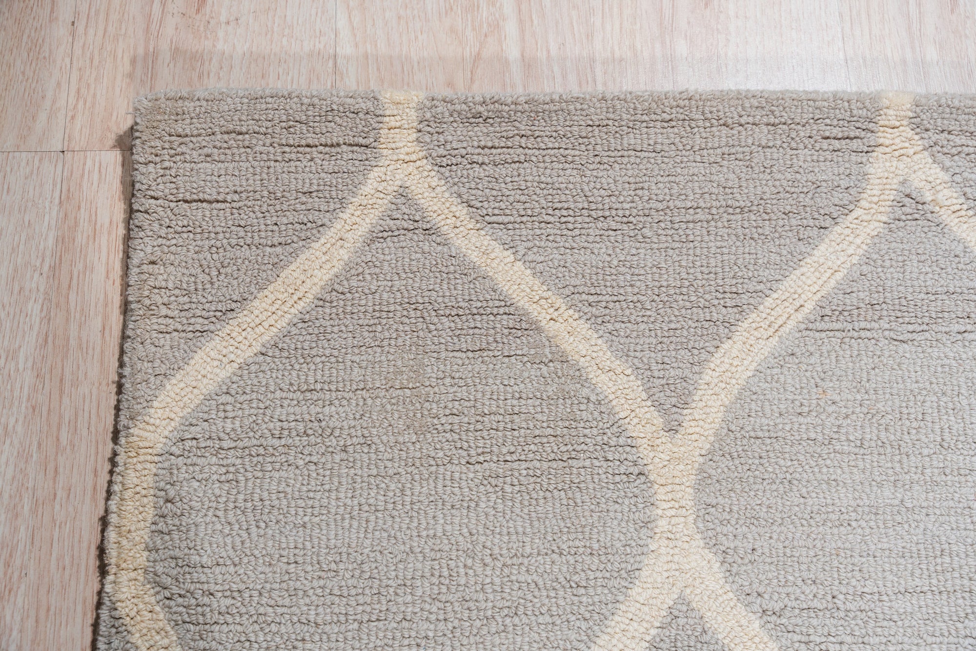 Classic Cozy Light Brown Hand Tufted Wool Rug, light brown texture fills the frame, showcasing the hand-tufted wool construction and subtle variations in shade.