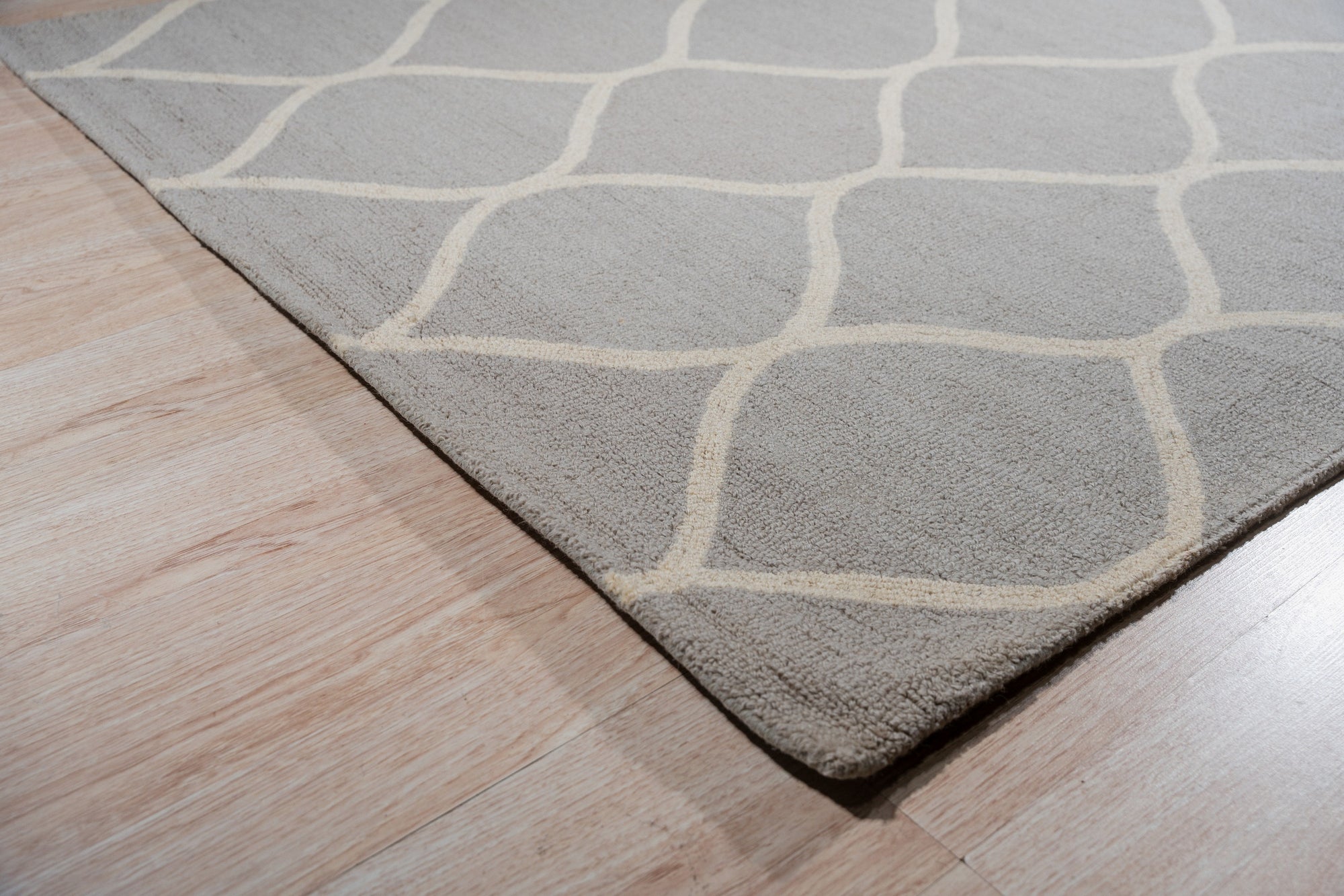 Classic Cozy Light Brown Hand Tufted Wool Rug, plush light brown wool texture fills the frame, showcasing its hand-tufted construction with subtle tonal variations adding depth.